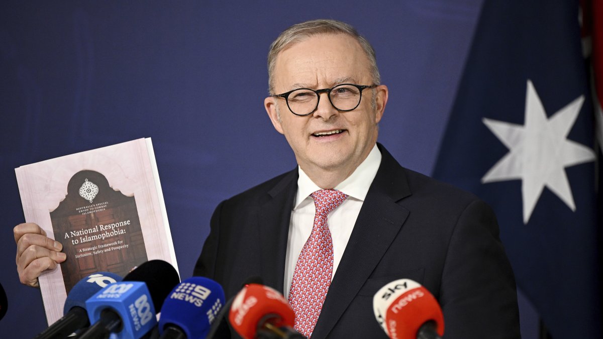 Australian Prime Minister Anthony Albanese holds a copy of the National Response to Islamophobia report as he speaks to the media during a press conference at the Commonwealth Parliamentary Offices, Sydney, Australia, Sept. 12, 2025. (AP Photo)