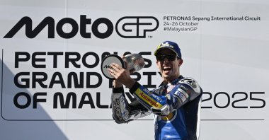 BK8 Gresini Racing MotoGP's Alex Marquez celebrates on the podium with the trophy after winning the Malaysian MotoGP race, Sepang, Malaysia, Oct. 26, 2025. (Reuters Photo)