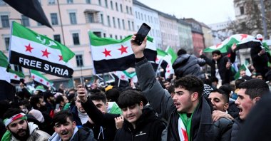 People wave Syrian opposition flags, as they gather at Oranienplatz square, after Syrian anti-regime forces announced that they have ousted dictator Bashar Assad, in Berlin, Germany Dec. 8, 2024. (Reuters File Photo)