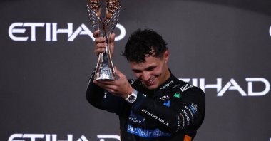 McLaren's Lando Norris celebrates on the podium with the trophy after becoming the 2025 Formula 1 World Champion, Abu Dhabi Grand Prix, Abu Dhabi, United Arab Emirates, Dec. 7, 2025. (Reuters Photo)