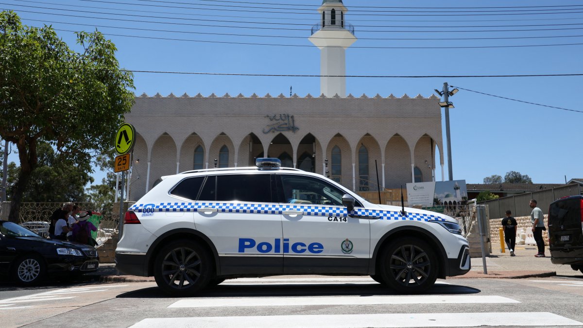 A police vehicle patrols outside Lakemba Imam Ali bin Abi Talib Mosque as people arrive for Friday prayers, amid a heightened security presence following the deadly mass shooting at Bondi Beach, Dec. 19, 2025. (Reuters Photo)