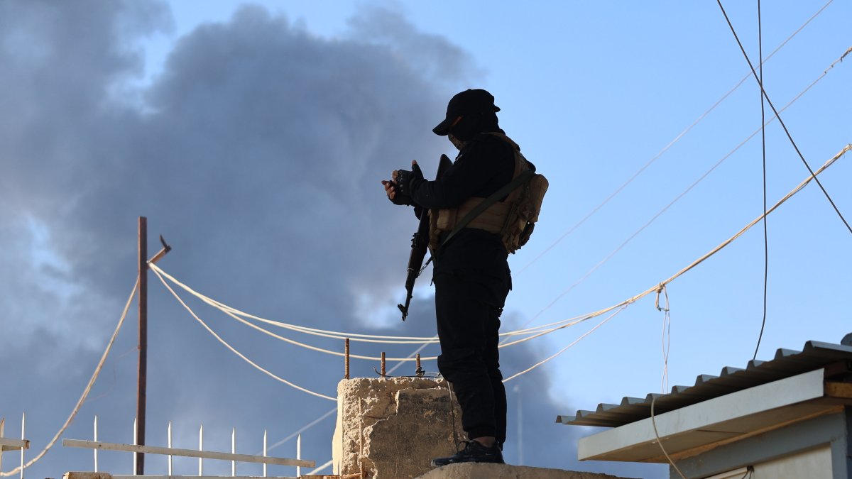 A member of the Syrian security forces stands in front of the gate of the al-Hol camp, in Hassakeh province, Syria, Jan. 21, 2026. (EPA Photo)