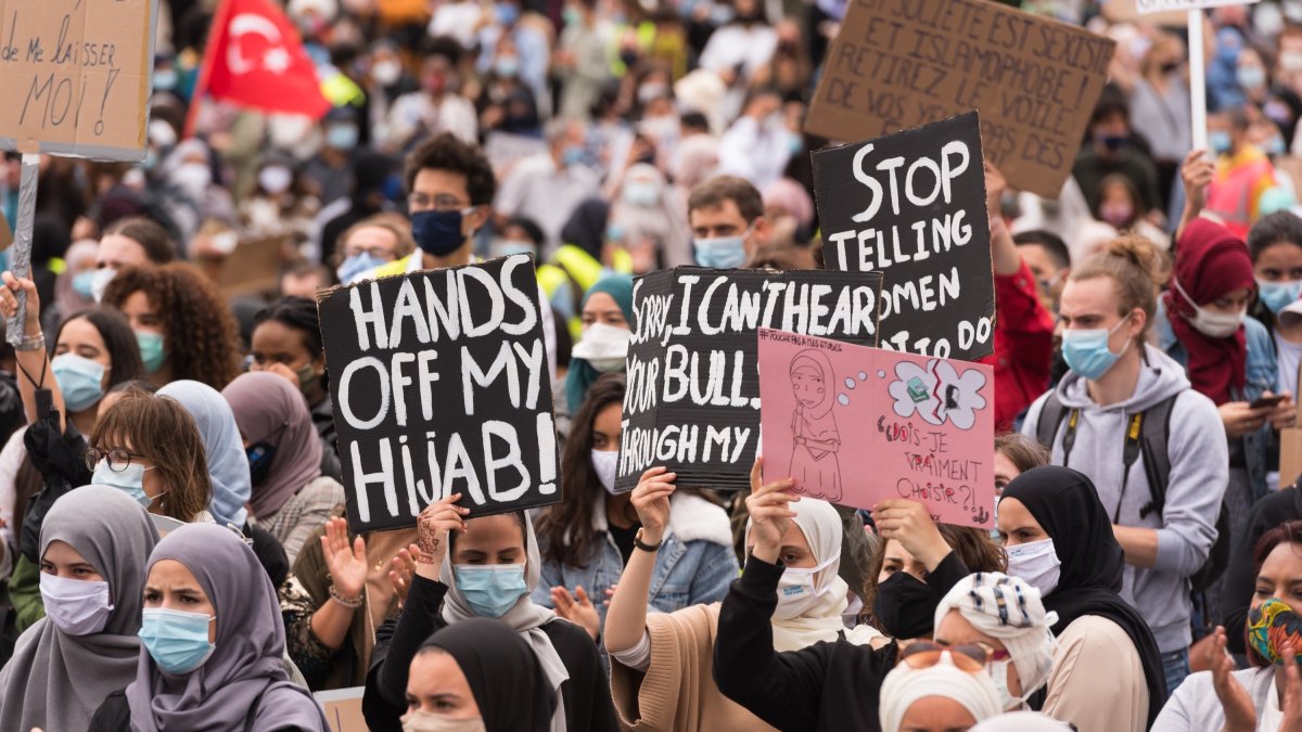 People hold placards protesting the headscarf ban at a Brussels college, Belgium, June 5, 2020. (Getty Images, File)