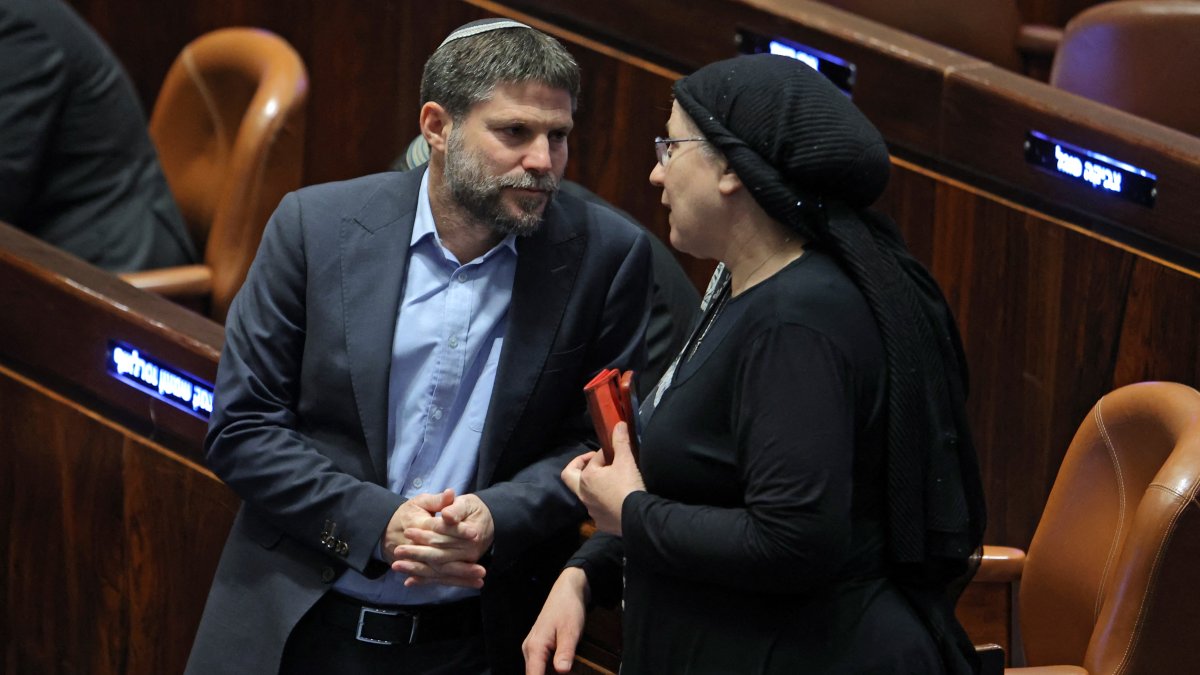Israeli Knesset (Israeli parliament) member Bezalel Smotrich (L), leader of the Religious Zionist Party, speaks with his colleague and party member Orit Strook (R) during a session elect the new speaker of the assembly at its Plenum Hall in Jerusalem, Dec. 13, 2022. (AFP Photo)