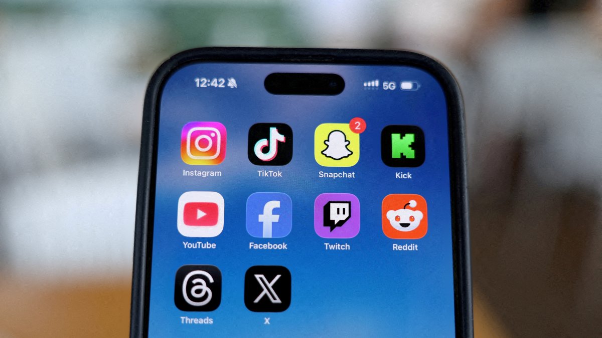 Instagram, TikTok, Snapchat, Kick, YouTube, Facebook, Twitch, Reddit, Threads and X applications are displayed on a mobile phone in this picture illustration, Dec.  9, 2025. (Reuters Photo)