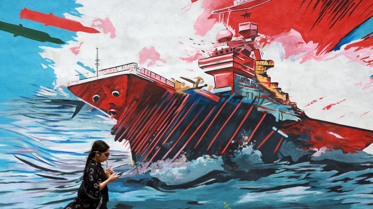 An Iranian walks next to an anti-U.S. mural in a street in Tehran, Iran, May 4, 2026. (EPA Photo)