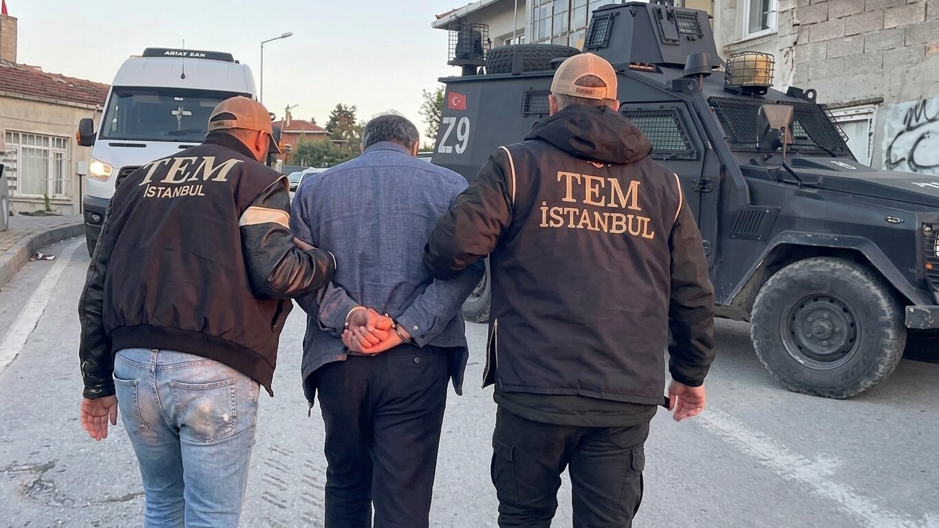 Two police officers escort a captured suspect in this AI-enhanced photo, Istanbul, Türkiye, May 7, 2026. (DHA Photo)